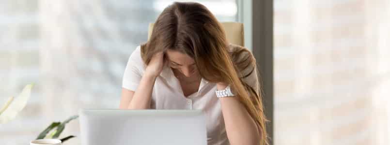 stressed woman sitting in front of a laptop