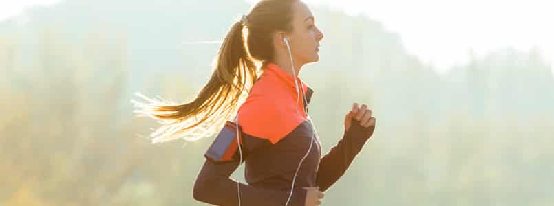 Woman running outdoors to boost metabolism for weight loss