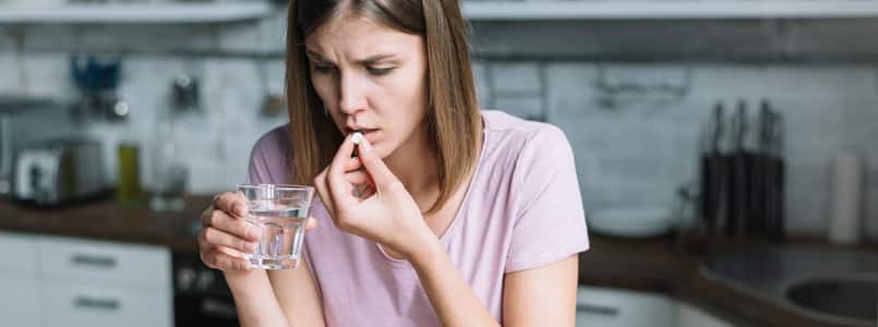 woman taking a pill