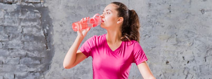 Woman drinking water to relieve a phentermine headache