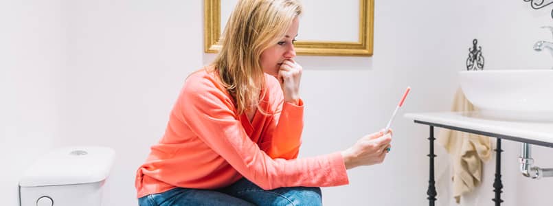 woman waiting nervously for the results of a pregnancy test