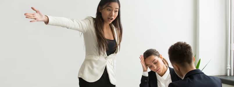 frustrated woman lecturing coworkers