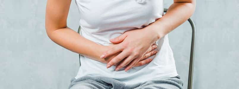 woman clutching stomach because of phentermine stomach pain