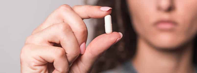 woman analyzing a pill