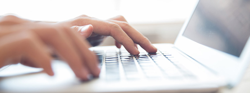 woman typing on a laptop