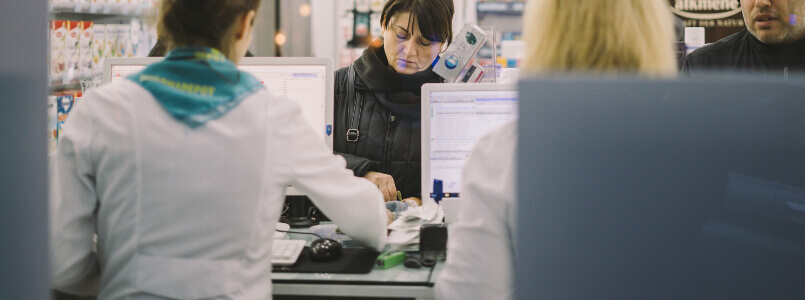 woman filling her prescription at a pharmacy
