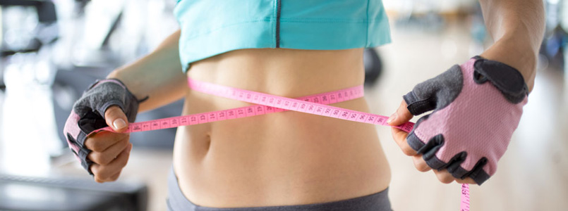 fit women measuring her waist