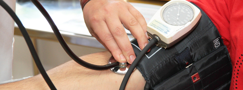 doctor measuring patient's blood pressure