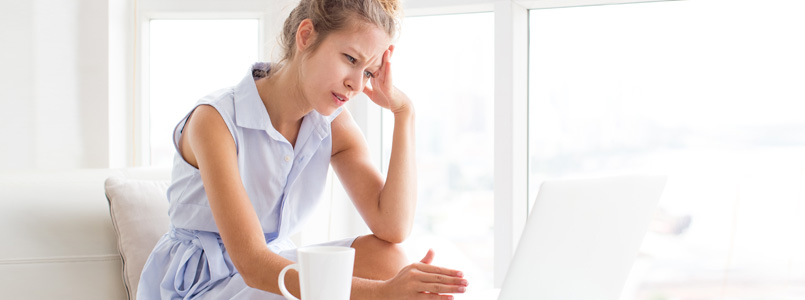 Woman holding her head as if she has a headache