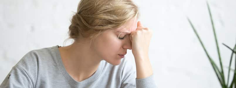 woman with a headache and fatigue from phentermine withdrawal